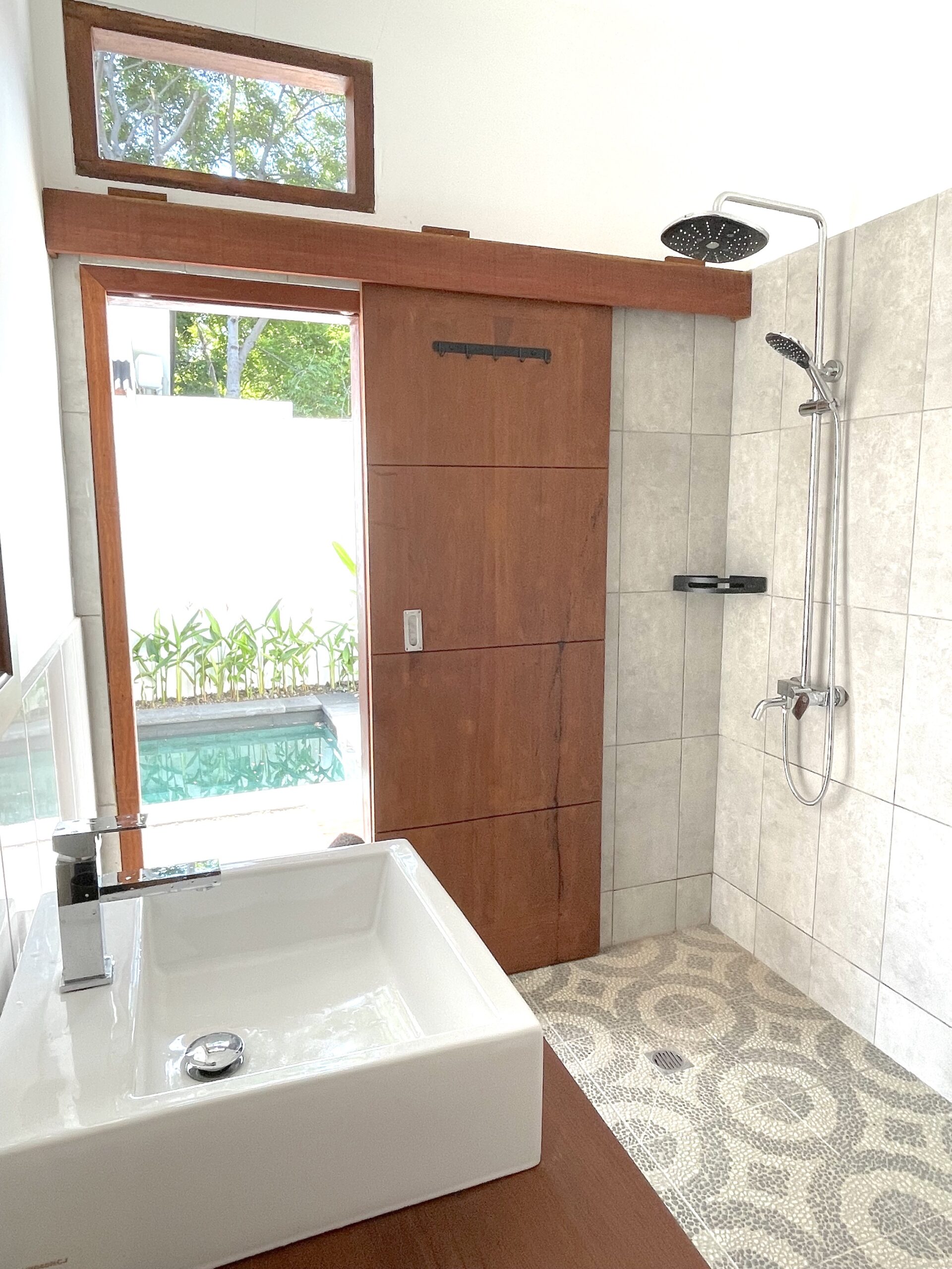 clean bathroom with a door to the pool 